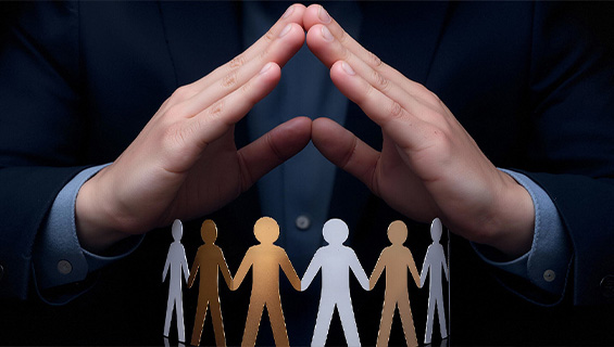 Hands sheltering a row of paper figures
